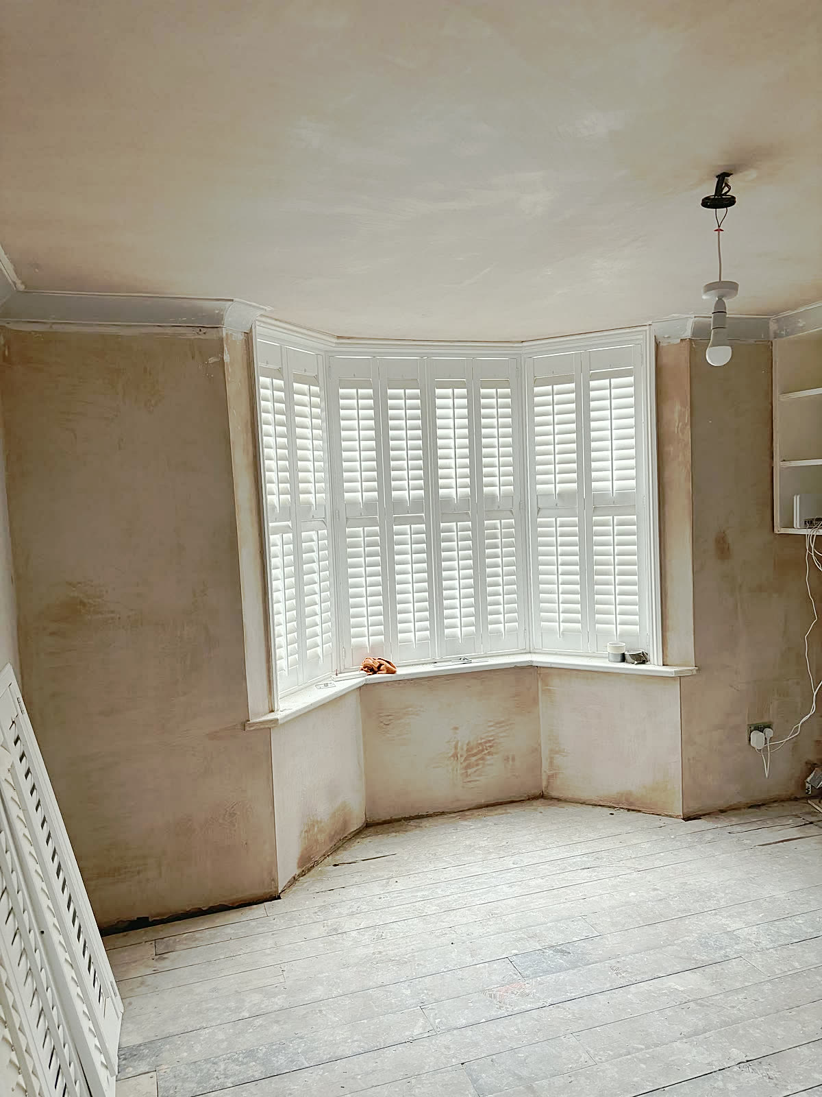 Bay-window room: walls skimmed → finished