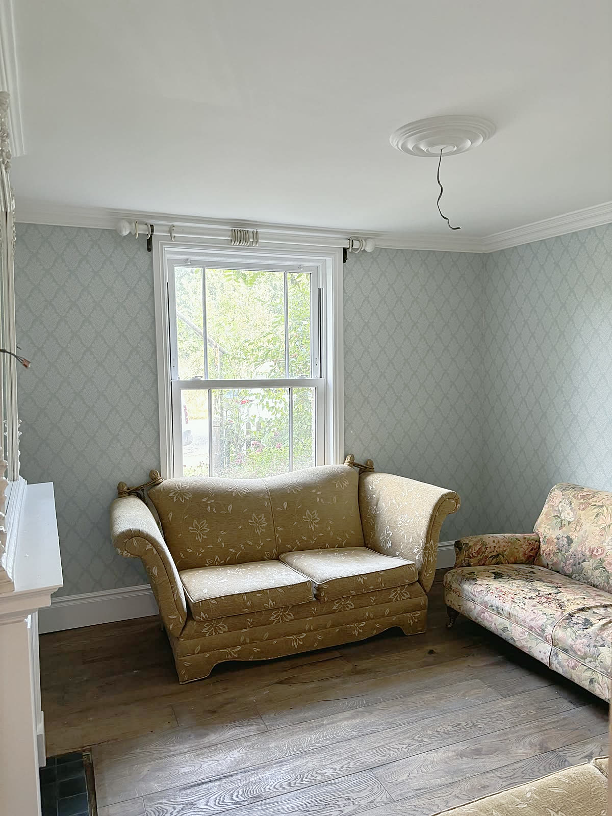 Wallpapered sitting room with new coving