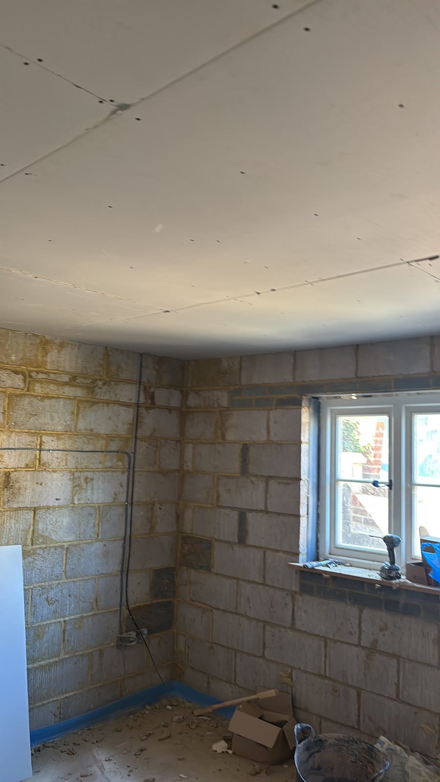 Ceiling boarded, blockwork walls still bare