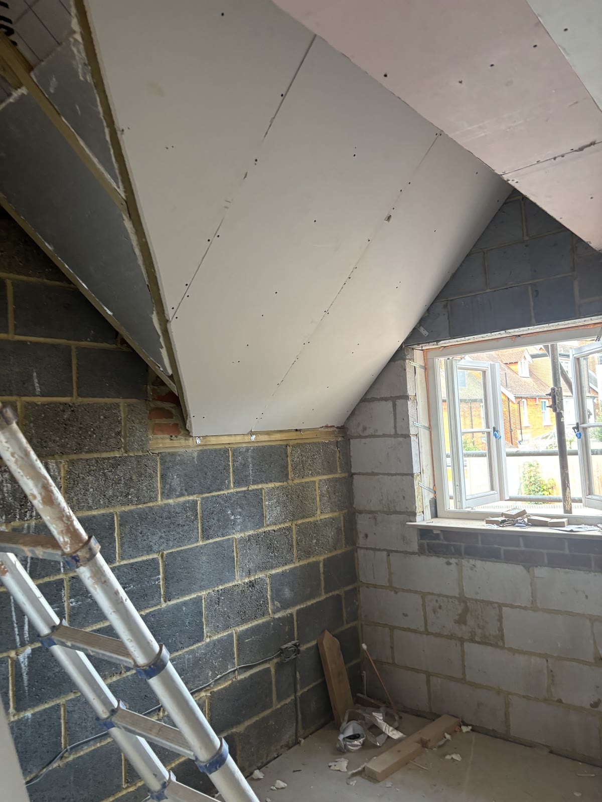 Loft room with sloped ceilings boarded