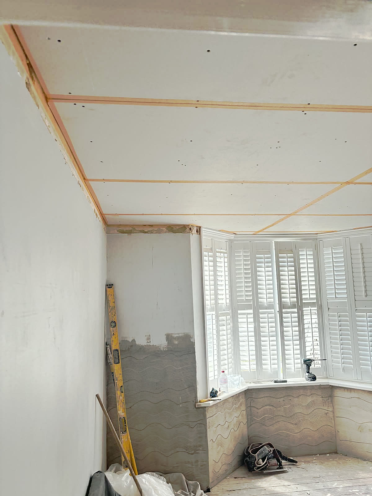 Bay-window room: ceiling boarded and taped