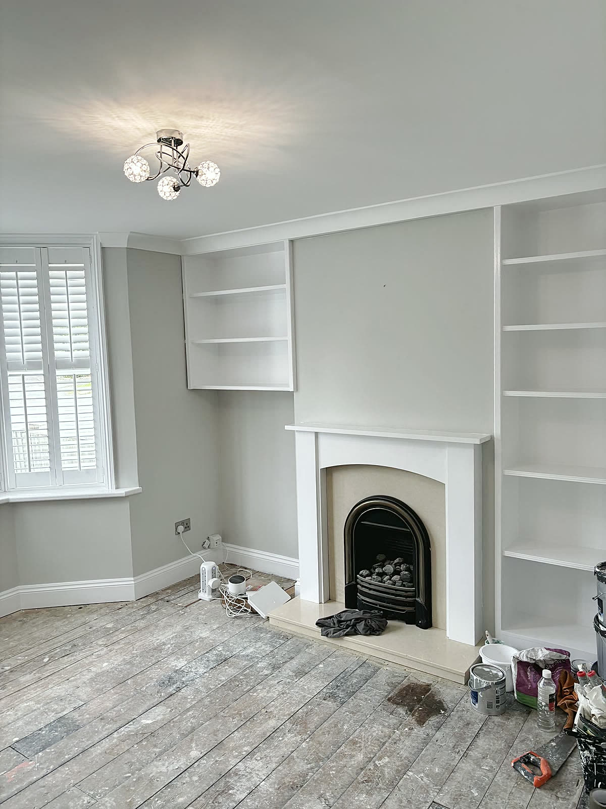 Fireplace wall finished, with the alcove shelving