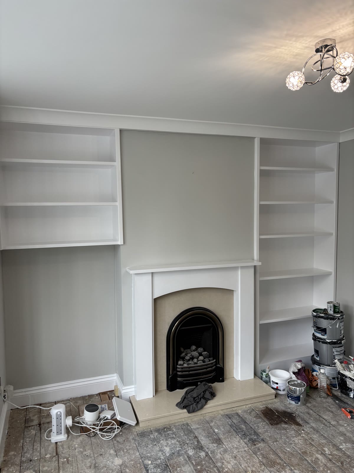 Fireplace wall and alcoves, seen straight on