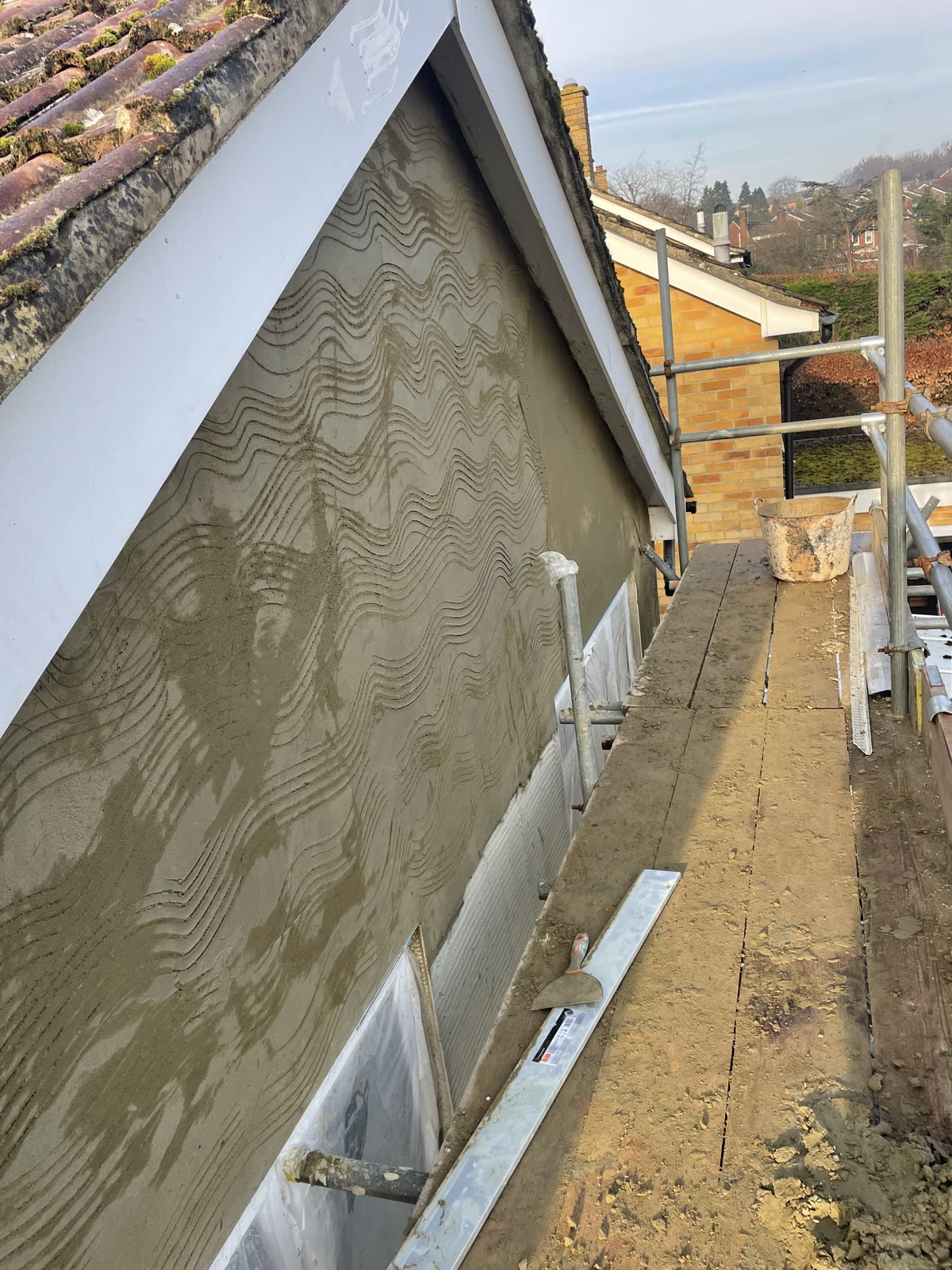 Scratch coat on a gable wall